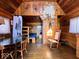 Rustic cabin interior showcasing wood walls, bunk beds, and a rocking chair, exuding cozy charm at 3559 N Us Highway 41, Bloomingdale, IN 47832