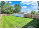Expansive backyard featuring a well-manicured lawn, a wooden fence and a detached garage at 3809 Wildwood Dr, Indianapolis, IN 46239