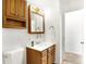 This quaint bathroom features a toilet and a wooden vanity for storage and functionality at 3809 Wildwood Dr, Indianapolis, IN 46239