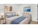 This bright bedroom features a queen bed, a dresser, and a serene piece of artwork to complete the room at 3809 Wildwood Dr, Indianapolis, IN 46239