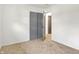 This simple bedroom features neutral carpet, freshly painted white walls, and a closet with sliding doors at 3809 Wildwood Dr, Indianapolis, IN 46239