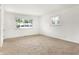 Bright, empty room with two windows and neutral carpet flooring at 3809 Wildwood Dr, Indianapolis, IN 46239