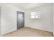 This simple bedroom features neutral carpet, freshly painted white walls, and a closet with sliding doors at 3809 Wildwood Dr, Indianapolis, IN 46239