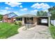 Quaint brick home with a covered carport and manicured lawn at 3809 Wildwood Dr, Indianapolis, IN 46239
