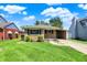 Charming brick home with green lawn and convenient covered parking at 3809 Wildwood Dr, Indianapolis, IN 46239