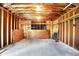 Spacious unfinished garage with exposed beams and plenty of room for storage and vehicles at 3809 Wildwood Dr, Indianapolis, IN 46239