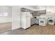 Efficient kitchen with gray cabinets, modern appliances, and laundry area at 3809 Wildwood Dr, Indianapolis, IN 46239