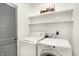 Dedicated laundry room with modern washer and dryer units and shelving at 3809 Wildwood Dr, Indianapolis, IN 46239