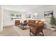 Bright living room features a comfortable brown couch and ample natural light at 3809 Wildwood Dr, Indianapolis, IN 46239