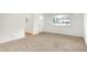 Inviting room with neutral carpet and a large window for ample sunlight at 3809 Wildwood Dr, Indianapolis, IN 46239
