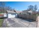 Exterior view of home with garage and paved driveway with privacy fence along the back yard at 4102 N Illinois St, Indianapolis, IN 46208