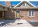 Close up of front door and brick exterior with garden bed and walkway at 4102 N Illinois St, Indianapolis, IN 46208