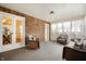 Cozy sunroom with wicker seating, brick walls, and plenty of natural light streaming through the windows at 4102 N Illinois St, Indianapolis, IN 46208