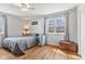 Bedroom features hardwood floors, bright window, and ceiling fan at 4159 Asbury St, Indianapolis, IN 46227