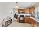 Kitchen with wood cabinets, black appliances, and tile floor at 4159 Asbury St, Indianapolis, IN 46227