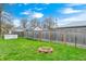Landscaped backyard featuring a brick fire pit and a well-maintained wooden fence at 438 N 11Th Ave, Beech Grove, IN 46107