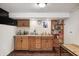 Basement bar area featuring wood cabinets, a sink, and ample counter space for entertaining at 438 N 11Th Ave, Beech Grove, IN 46107