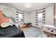 bedroom featuring striped curtains, modern lighting and a geometric circle wall design at 438 N 11Th Ave, Beech Grove, IN 46107