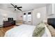Cozy bedroom featuring a crib, dresser, and comfy queen size bed with a ceiling fan for climate control at 438 N 11Th Ave, Beech Grove, IN 46107