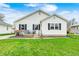 Charming home featuring a well-maintained lawn and a welcoming front porch with seating at 438 N 11Th Ave, Beech Grove, IN 46107