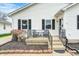 Inviting front porch with chairs and a small table, perfect for relaxing and enjoying the outdoors at 438 N 11Th Ave, Beech Grove, IN 46107