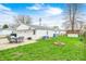 Detached one-car garage in back yard with outdoor dining set and green space at 438 N 11Th Ave, Beech Grove, IN 46107
