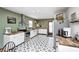 Modern kitchen featuring butcher block countertops, stainless steel appliances, and decorative flooring at 438 N 11Th Ave, Beech Grove, IN 46107
