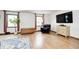 Spacious living room with hardwood floors, ample natural light, and modern entertainment setup at 438 N 11Th Ave, Beech Grove, IN 46107