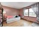 Bright living room with a large window, comfortable seating, and hardwood floors, creating a welcoming space at 438 N 11Th Ave, Beech Grove, IN 46107
