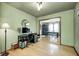 Spacious office area flows into dining room, featuring sleek desk and hardwood floors, perfect for modern living at 438 N 11Th Ave, Beech Grove, IN 46107