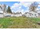 A fenced backyard shows green grass and several houses at 4618 W Beecher St, Indianapolis, IN 46241