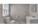 Bathroom featuring new toilet, single vanity sink, and window at 4618 W Beecher St, Indianapolis, IN 46241
