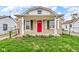 Charming home featuring a red front door, stone accents, and a covered porch at 4618 W Beecher St, Indianapolis, IN 46241