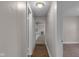 Hallway with hardwood floors and neutral walls at 4618 W Beecher St, Indianapolis, IN 46241