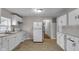Kitchen featuring white appliances and cabinets, offering a clean design at 4618 W Beecher St, Indianapolis, IN 46241