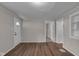 Neutral living room with hardwood floors, a white front door and several entryways at 4618 W Beecher St, Indianapolis, IN 46241