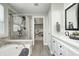 This bathroom features a soaking tub with shower, double sinks, and neutral tile at 4644 Shelby Cir, Greenwood, IN 46143