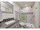 Updated bathroom with tiled walk-in shower, a gray vanity, and a framed mirror at 4644 Shelby Cir, Greenwood, IN 46143