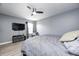 A cozy bedroom with a ceiling fan, tv, and natural light, creating a tranquil space at 4644 Shelby Cir, Greenwood, IN 46143