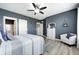 Stylish bedroom featuring blue accent wall, ceiling fan, and elegant furnishings at 4644 Shelby Cir, Greenwood, IN 46143