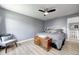 Bedroom with a ceiling fan, laminate floors, and a sitting chair, perfect for relaxation at 4644 Shelby Cir, Greenwood, IN 46143