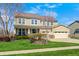 Charming two-story home features a welcoming porch and attached two car garage with well-maintained landscaping at 4644 Shelby Cir, Greenwood, IN 46143