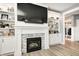 Close up of a fireplace featuring built-in shelves, stylish decor, and a contemporary design at 4644 Shelby Cir, Greenwood, IN 46143