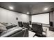 A home theater with multiple leather recliners, cup holders, and a large movie screen for entertainment at 4644 Shelby Cir, Greenwood, IN 46143