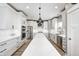Modern kitchen features white cabinets, stainless steel appliances, and a center island with a white countertop at 4644 Shelby Cir, Greenwood, IN 46143