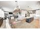 Bright open floor plan with a kitchen featuring a large island, white cabinets and stainless appliances at 4644 Shelby Cir, Greenwood, IN 46143