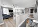 Upstairs living room with staircase, cozy seating, and lots of natural light at 4644 Shelby Cir, Greenwood, IN 46143