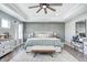 This main bedroom offers a tray ceiling, wood accent wall, and ceiling fan for a cozy feel at 4644 Shelby Cir, Greenwood, IN 46143