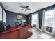 Bright home office features dual monitors, wood desk, and natural light from the windows at 4644 Shelby Cir, Greenwood, IN 46143