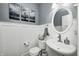 Well-lit powder room features a pedestal sink and modern decor at 4644 Shelby Cir, Greenwood, IN 46143